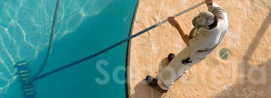 Image of a person cleaning the swimming pool , Sabbatella Pool and Spa , Pool Service Woodland Hills CA.