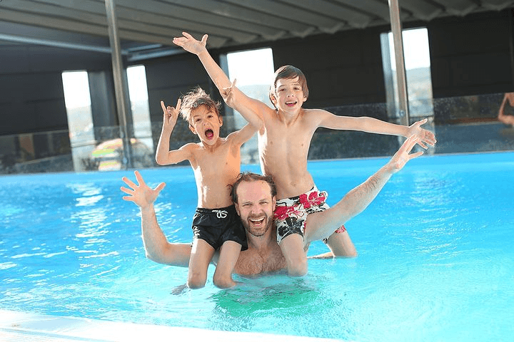 Image of a family in the swimming pool , Sabbatella pool and spa , Pool Repair Woodland Hills CA.