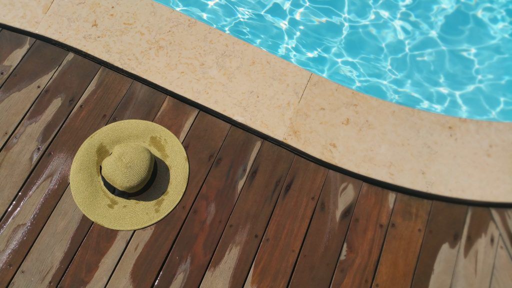 Image of a hat beside the swimming pool , Sabbatella pool and spa , pool Contractors Woodland Hills CA.